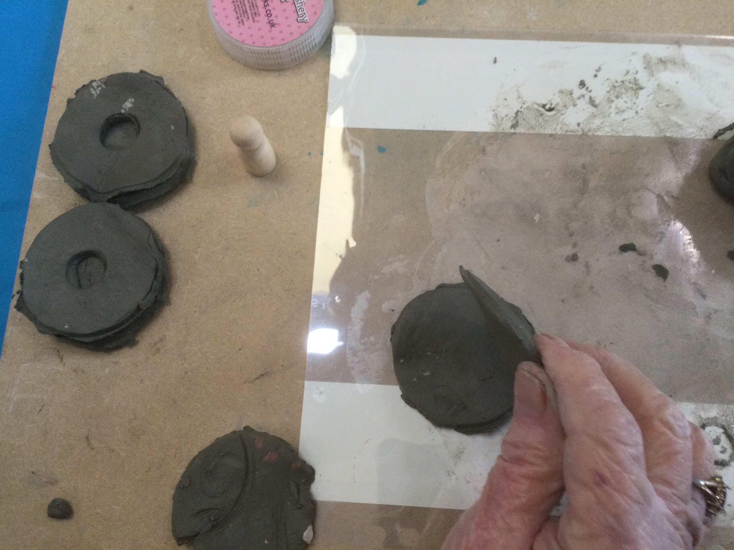 Various circles cut out of damp clay
