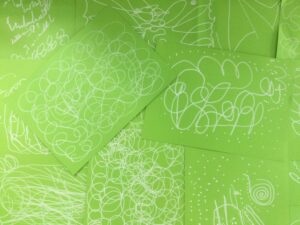 White decorative lines on green paper