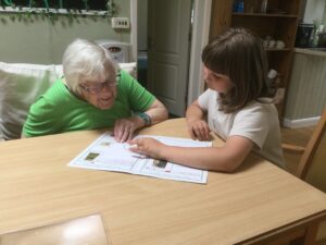 A child points something out to one of the residents