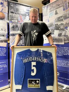 Rob Atherton holding a framed football shirt