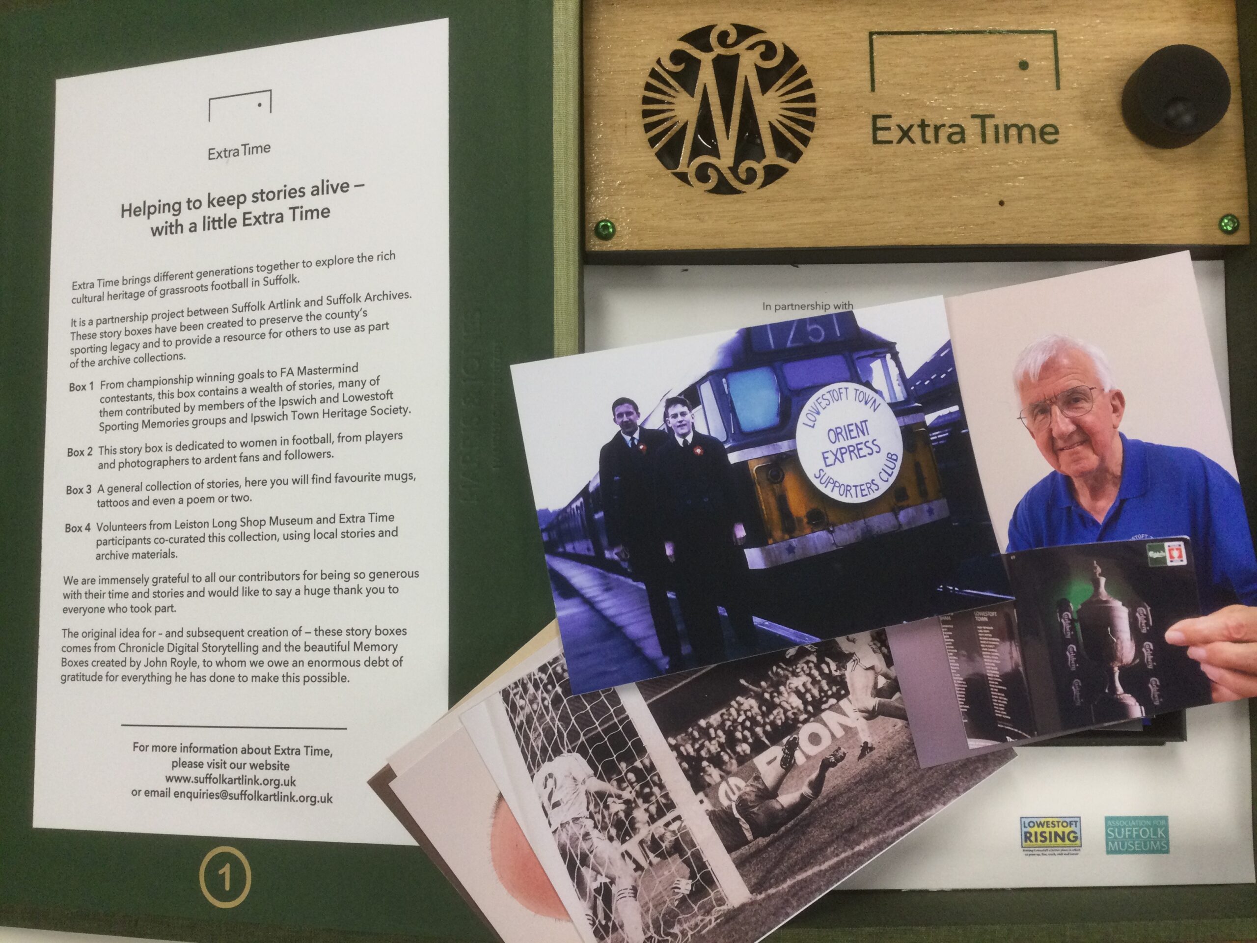 Interior of story box, showing a small selection of the images, including two men standing at the front of a train with Lowestoft Town Supporters Club Orient Express written on the front