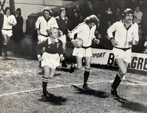 Young Clive Penning going onto pitch as mascot