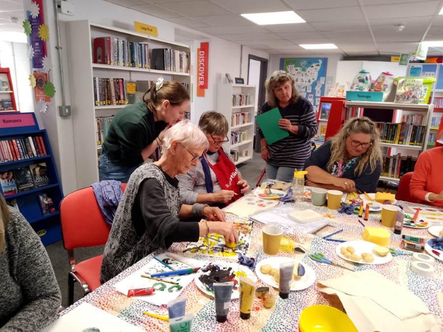 people sitting at a table print making.