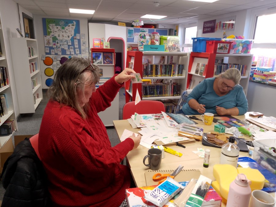 woman creating decorated paper mobile