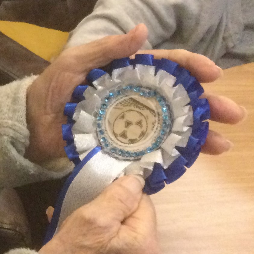 Close up of hand-decorated rosette