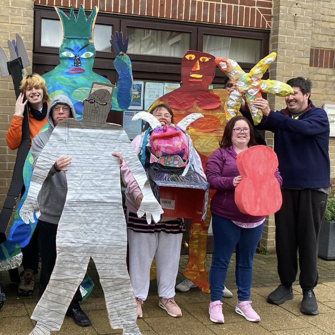 Brave Art students holding their people sized sculptures