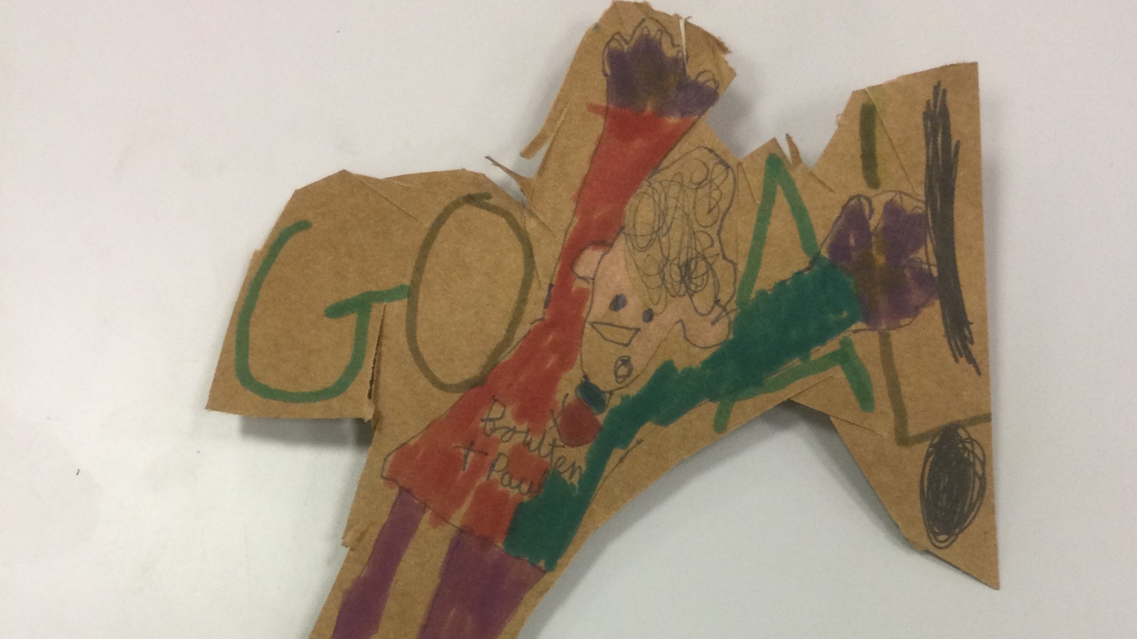 A brown cardboard football figure with word GOAL written behind and Boulton and Paul written on his jersey