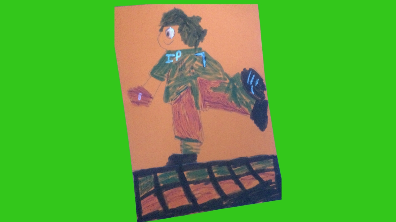 A hand coloured football figure with leg outstretched balancing a football. Green top, red shorts with IP7 on jersey