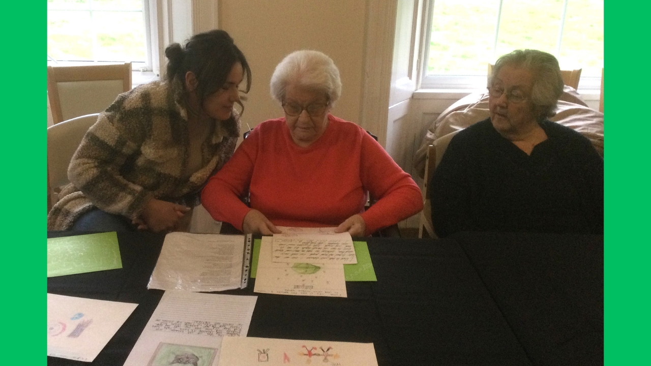 Three women studying some handwritten notes