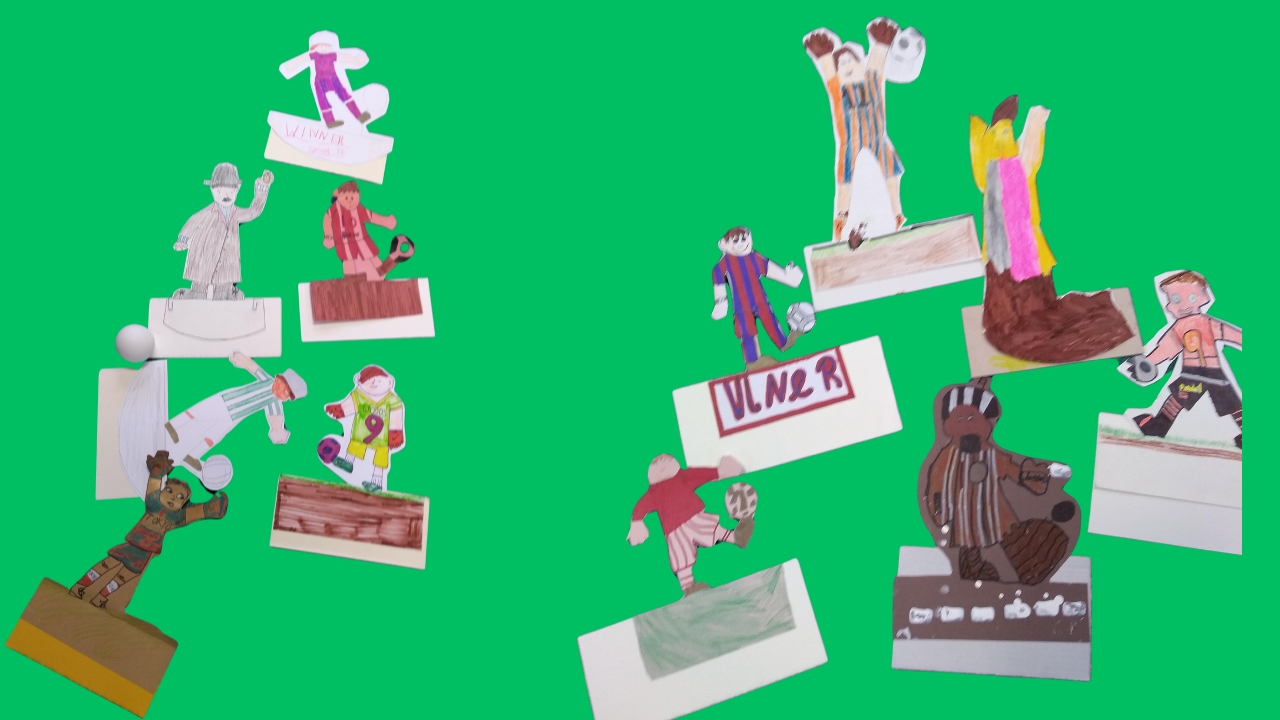 Numerous cut-our figures of football characters on a green background