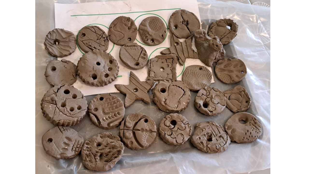 A tray full of clay shapes looking very much like chocolate biscuits